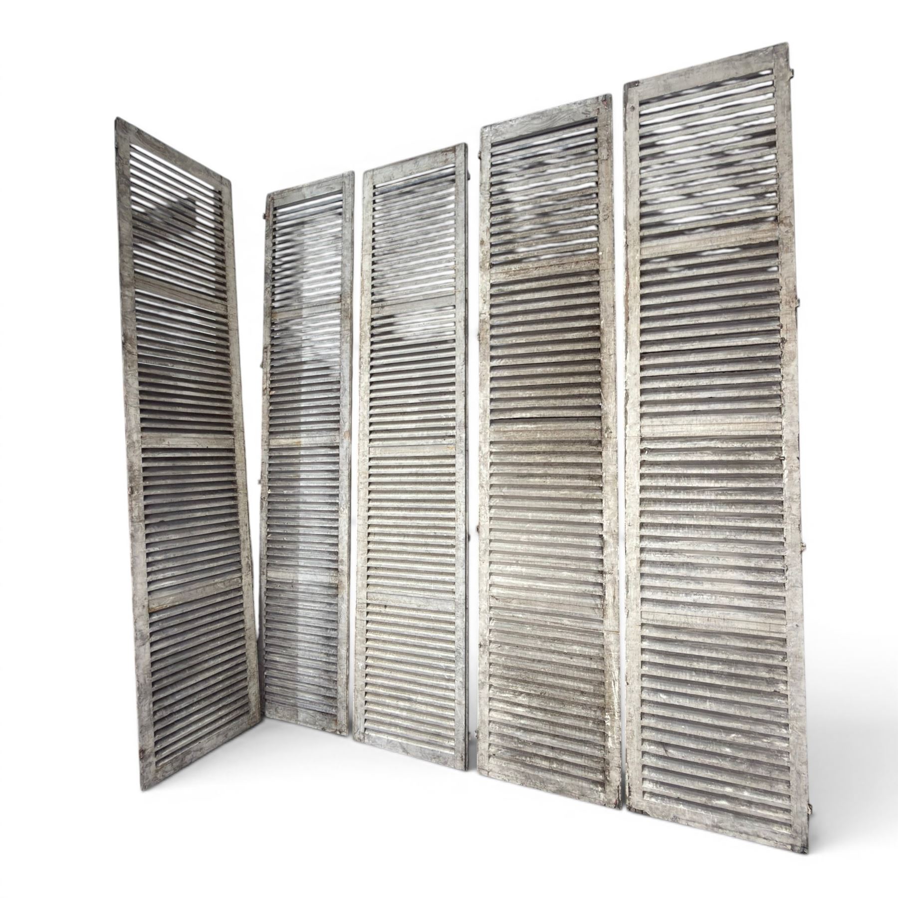 Five 19th century full height French Chateau louvre doors, pitch pine painted in cream finish, two having iron rod hinges, dimensions approx.