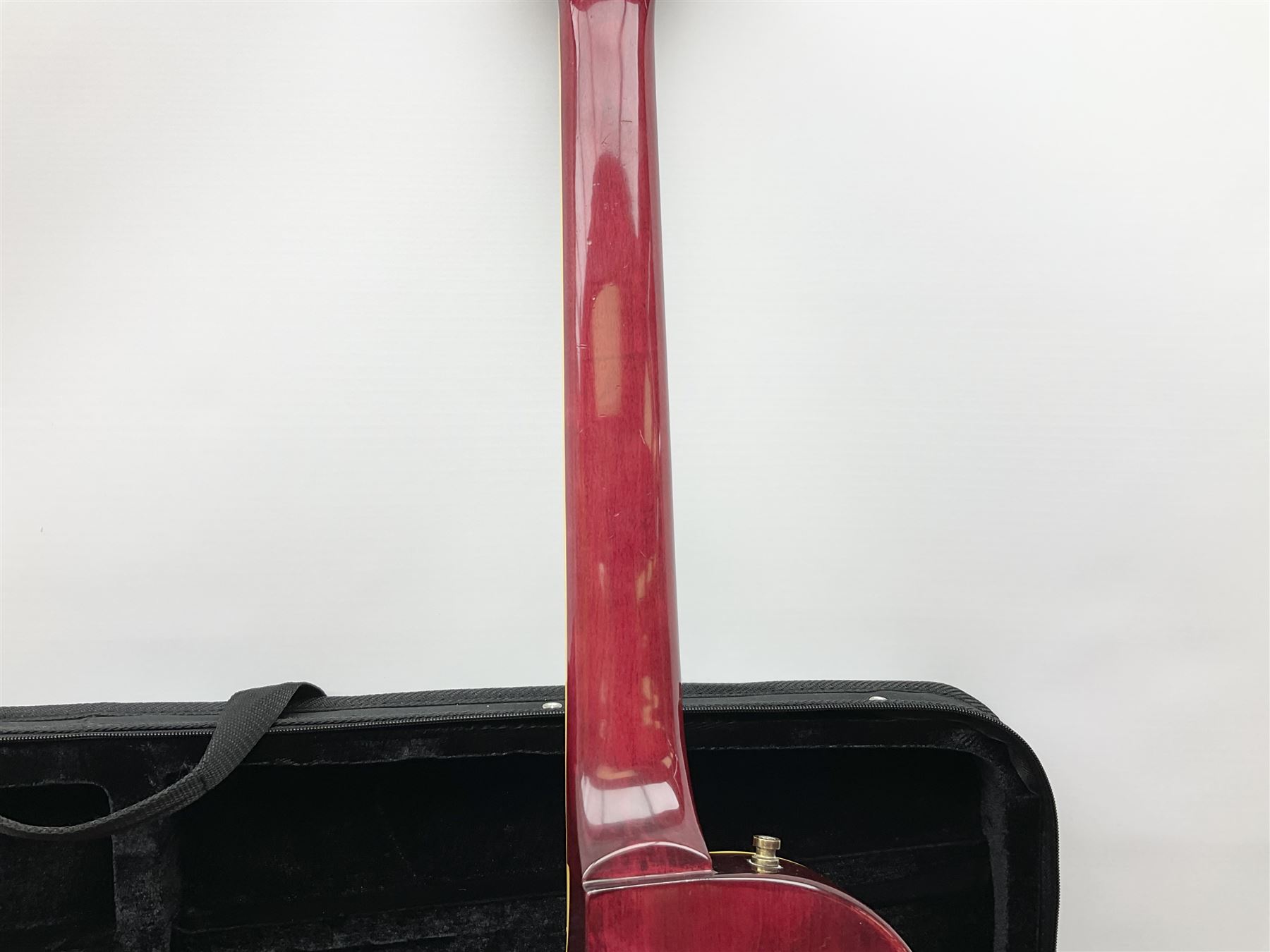 1980s Les Paul Epiphone limited edition cut-away electric guitar by Gibson, the burgundy coloured body with two pick-ups, volume and tone knobs and scratch plate, original tuning pegs, serial no.U6030215, 101cm overall; in modern Kinsman fitted carrying case