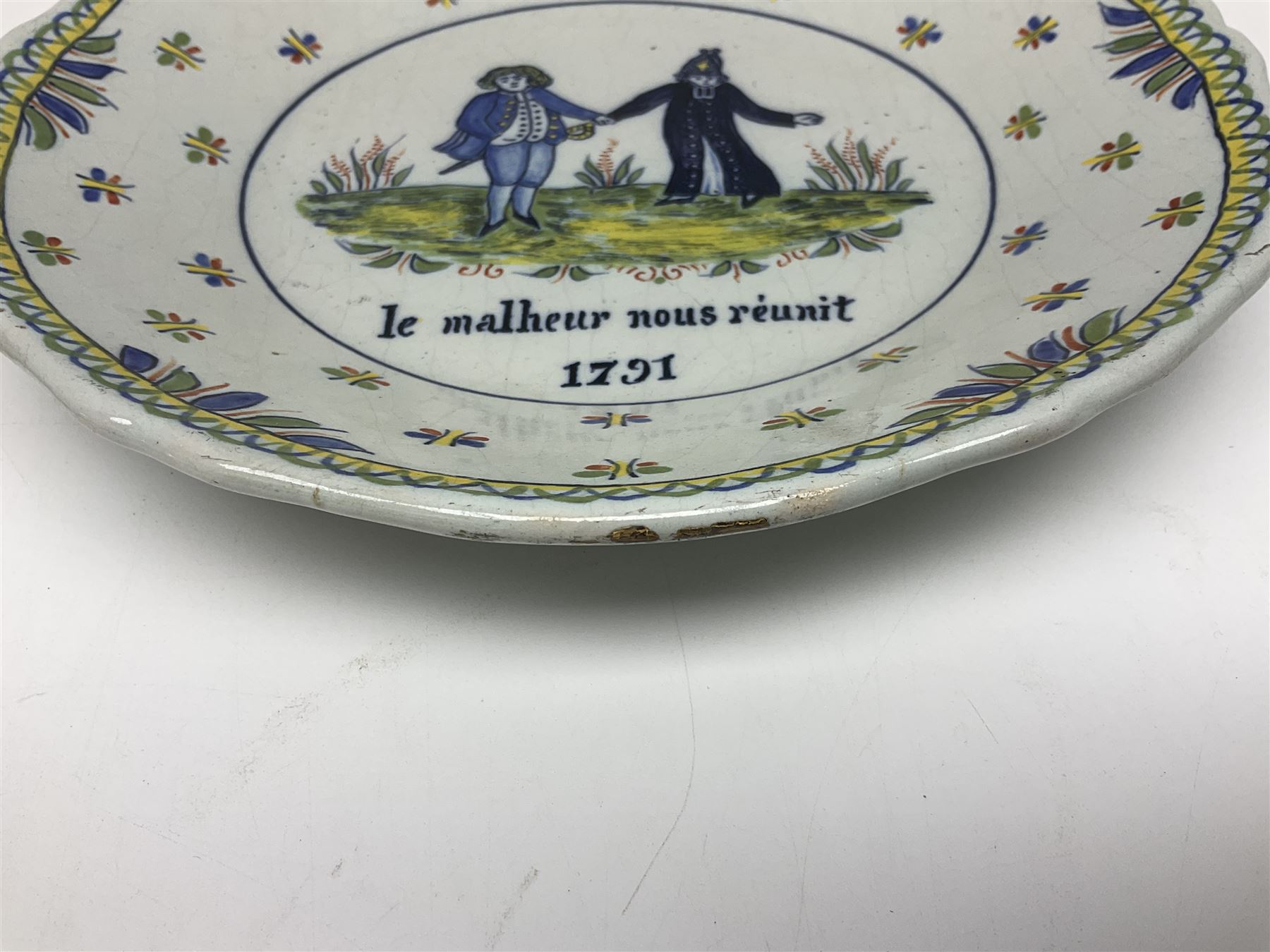 Four French Faience plates, comprising Je suis las de le porter, Le malheur nous reunit, Je desire y arriver and Eveque de Meaux, D24cm  