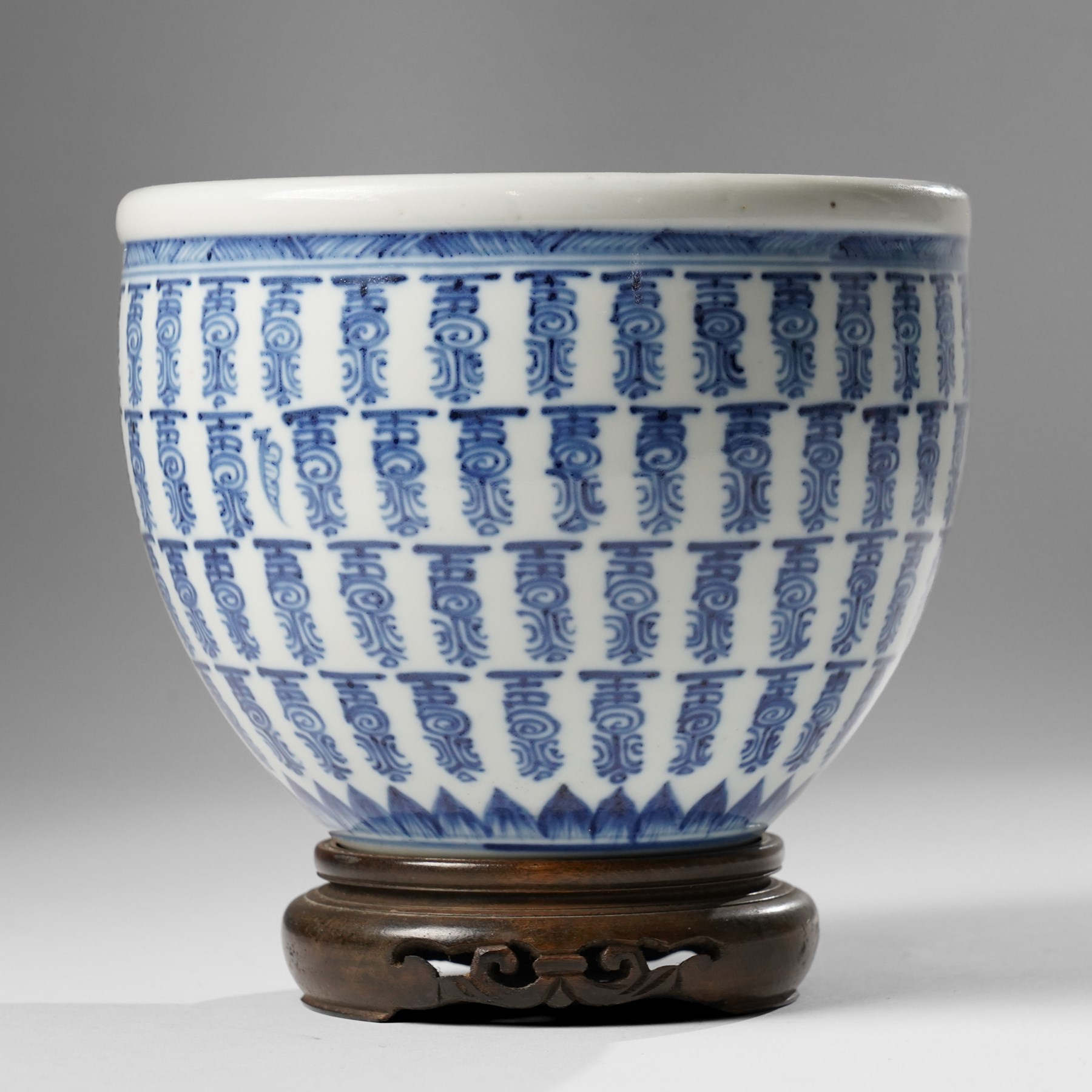 Chinese fish bowl, painted profusely with repeating symbols in blue, on hardwood stand, unmarked, including stand H16cm