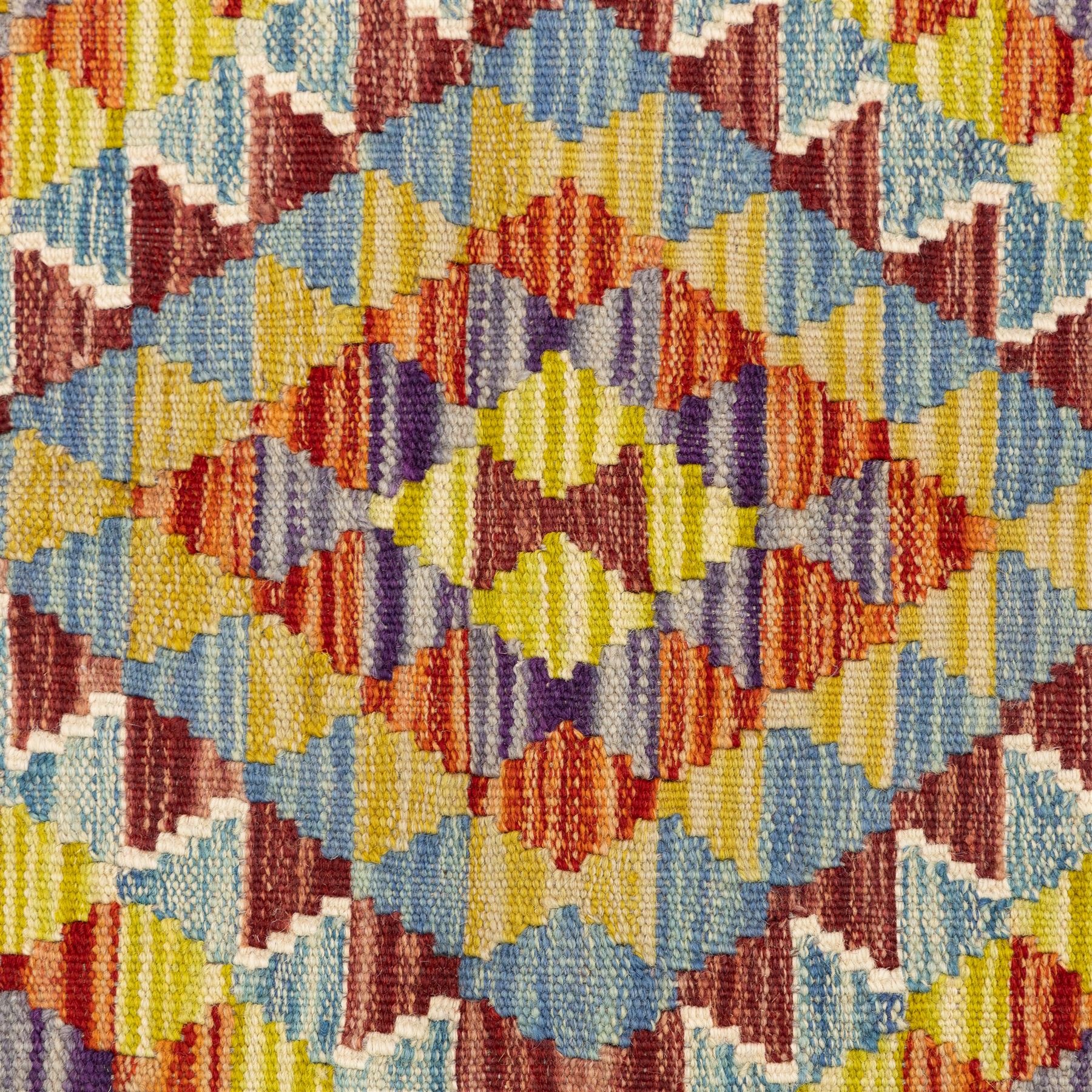 Two Chobi flatweave kilims with a repeating stepped diamond medallion design in live green, rust, teal, purple, and ivory, framed by chevron and geometric borders, 121x80cm & 87x60cm 