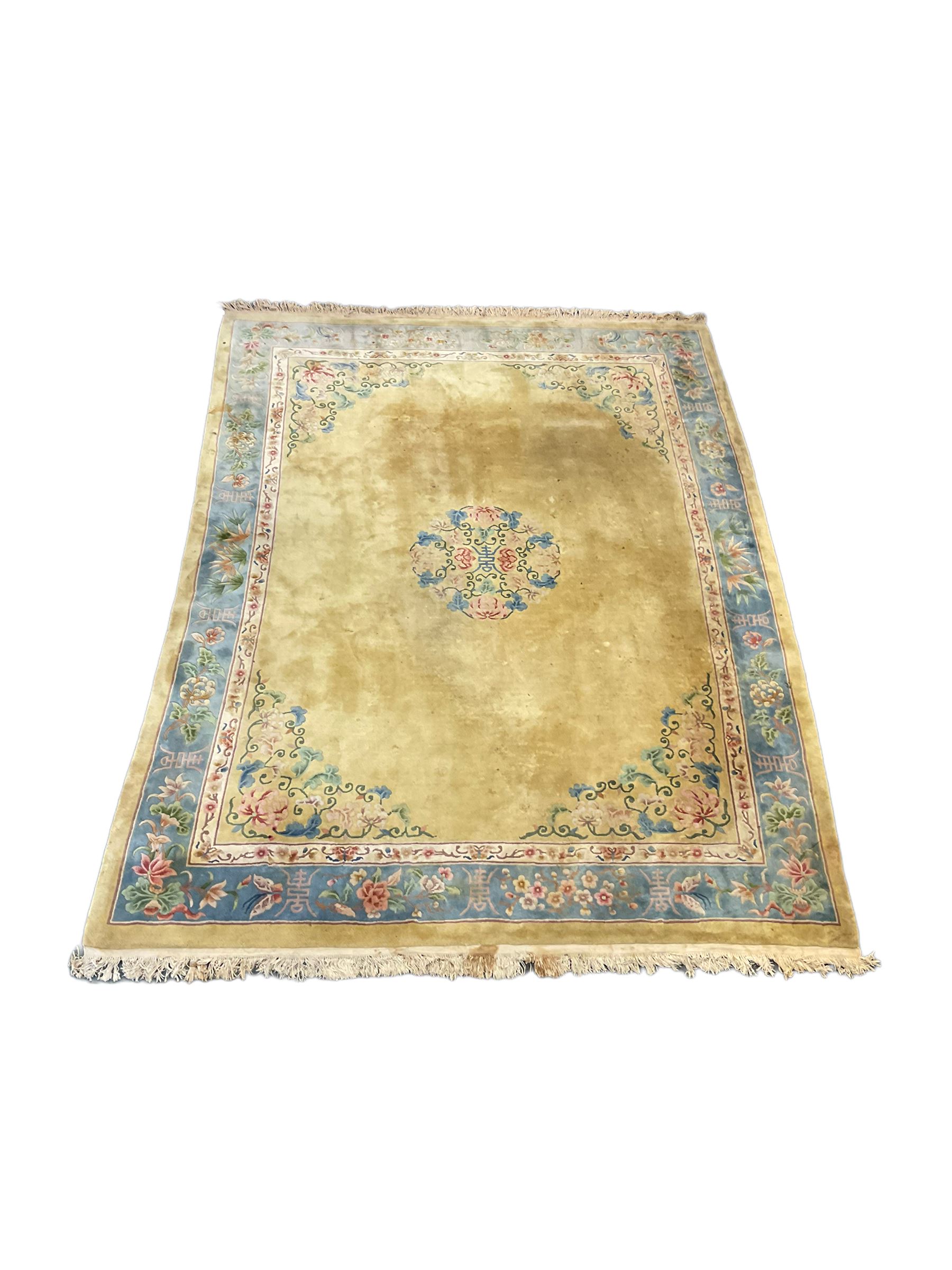 Large Chinese washed woollen carpet, pale sage green ground and decorated with flowers