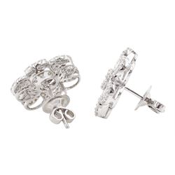 Pair of 18ct white gold baguette and round brilliant cut diamond daisy flower head stud earrings, stamped, total diamond weight approx 2.50 carat