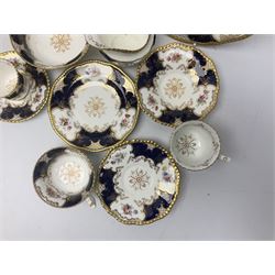 Coalport cobalt blue batwing pattern tea wares, decorated with finely enamelled floral sprays within gilt reserves, comprising teacup trio, coffee can and saucer and other cup and saucer, twin handled cake plate, milk jug and open sucrier, and circular plate retailed by T. Goode & Co London, pattern no Y2665,  all with green Coalport AD 1750 marks beneath, largest W26cm (11)