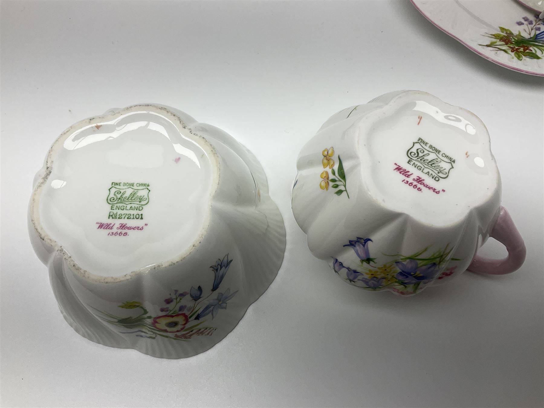 Shelley Wild Flowers pattern part tea service, comprising four cups and saucers, four dessert plates, cake plate, milk jug and open sucrier