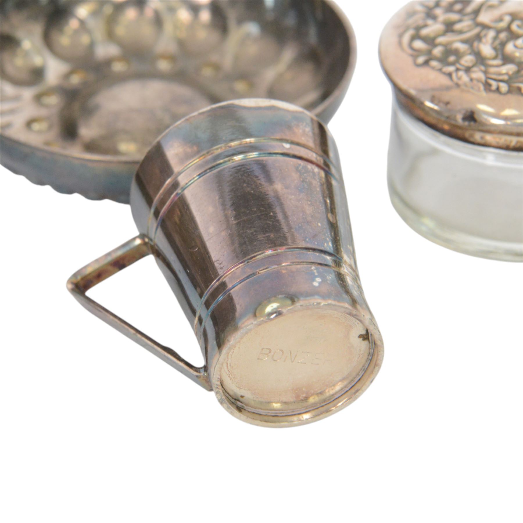 Silver mounted trinket box, with embossed lid, hallmarked, silver lidded glass jar stamped sterling, silver plated measure and a silver plated dish