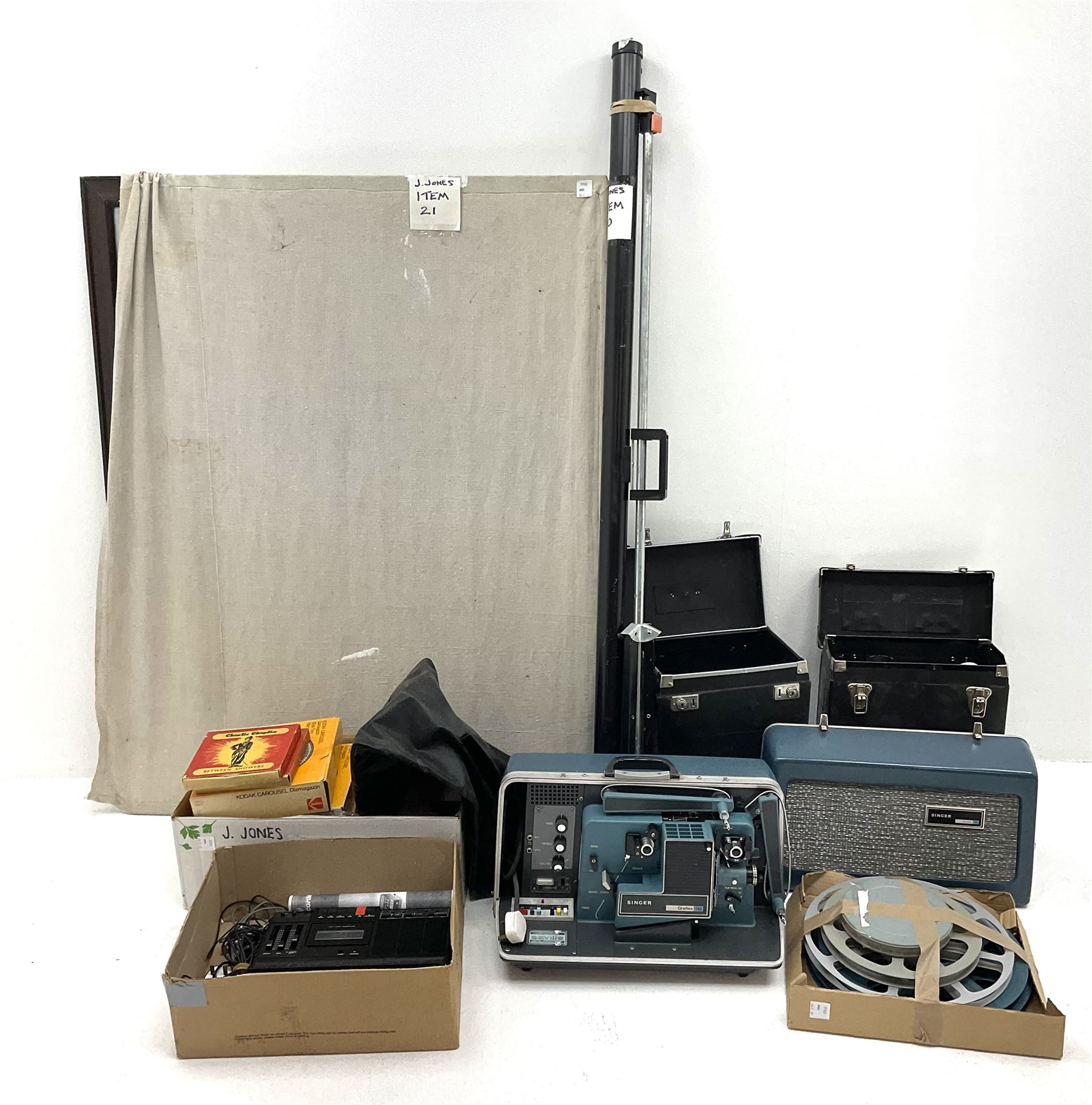 Kodak Carousel S-AV 2020 and 2050 35mm slide projectors, Kodak S-AV cassette recorder 200, Kodak S-AV programmable dissolve control, two Kodak slide carousels and a metal stand; a Singer Graflex 16 cine projector, two 16mm Charlie Chaplin film reels with sound 'Between Showers' and 'Oh What a Night', and five film spools; freestanding roll-up projection screen, and a wood framed reflective daylight projection screen