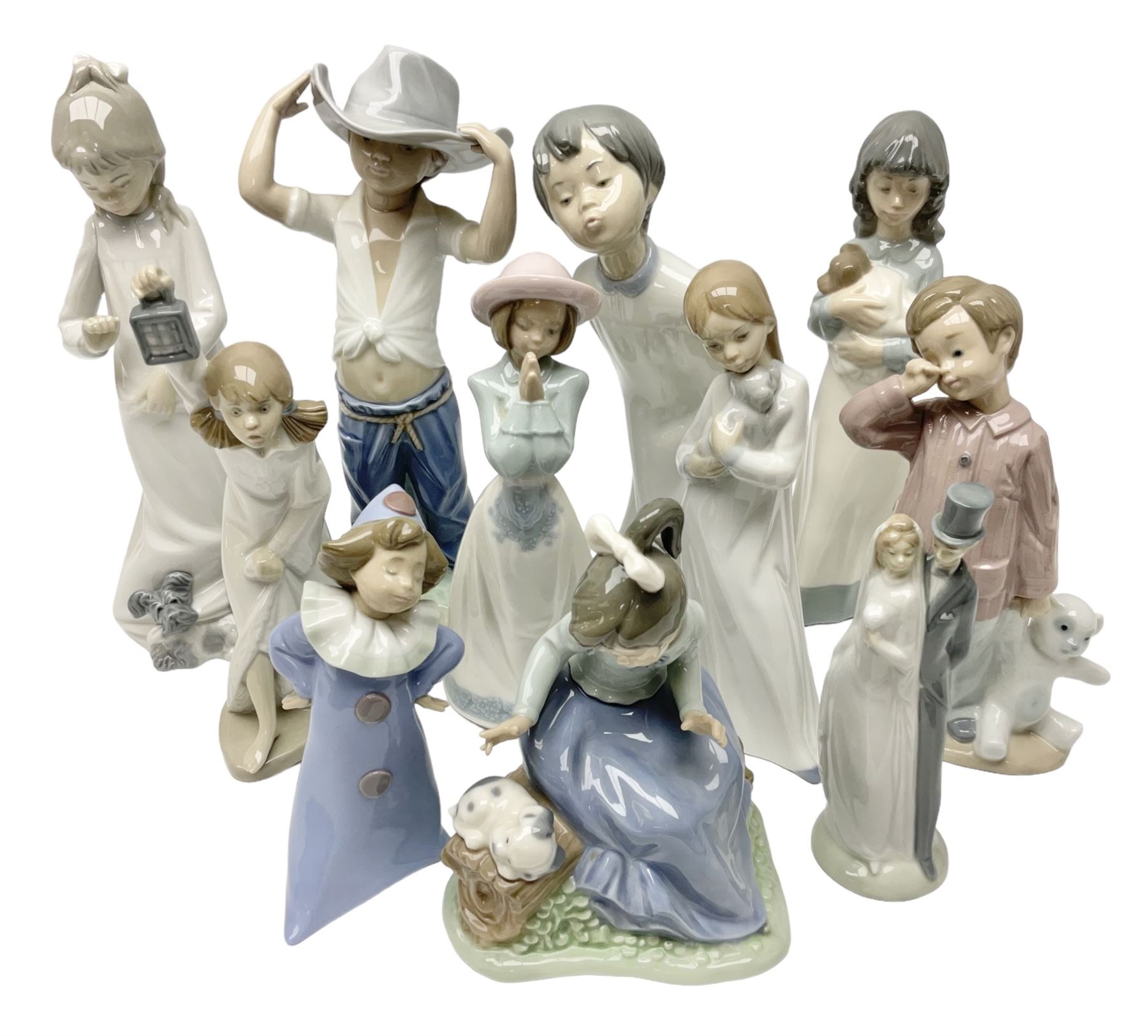 Eleven Nao figures to include Cowboy, Girl with Puppy, Clown, Girl in hat etc 