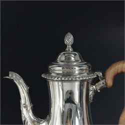 Modern three piece silver tea service, comprising coffee pot, teapot and milk jug, each of spherical form, upon circular domed foot, the teapot and coffee pot with wooden handles, the teapot with wooden finial, hallmarked Bryan Savage, London 1975, coffee pot H29cm
