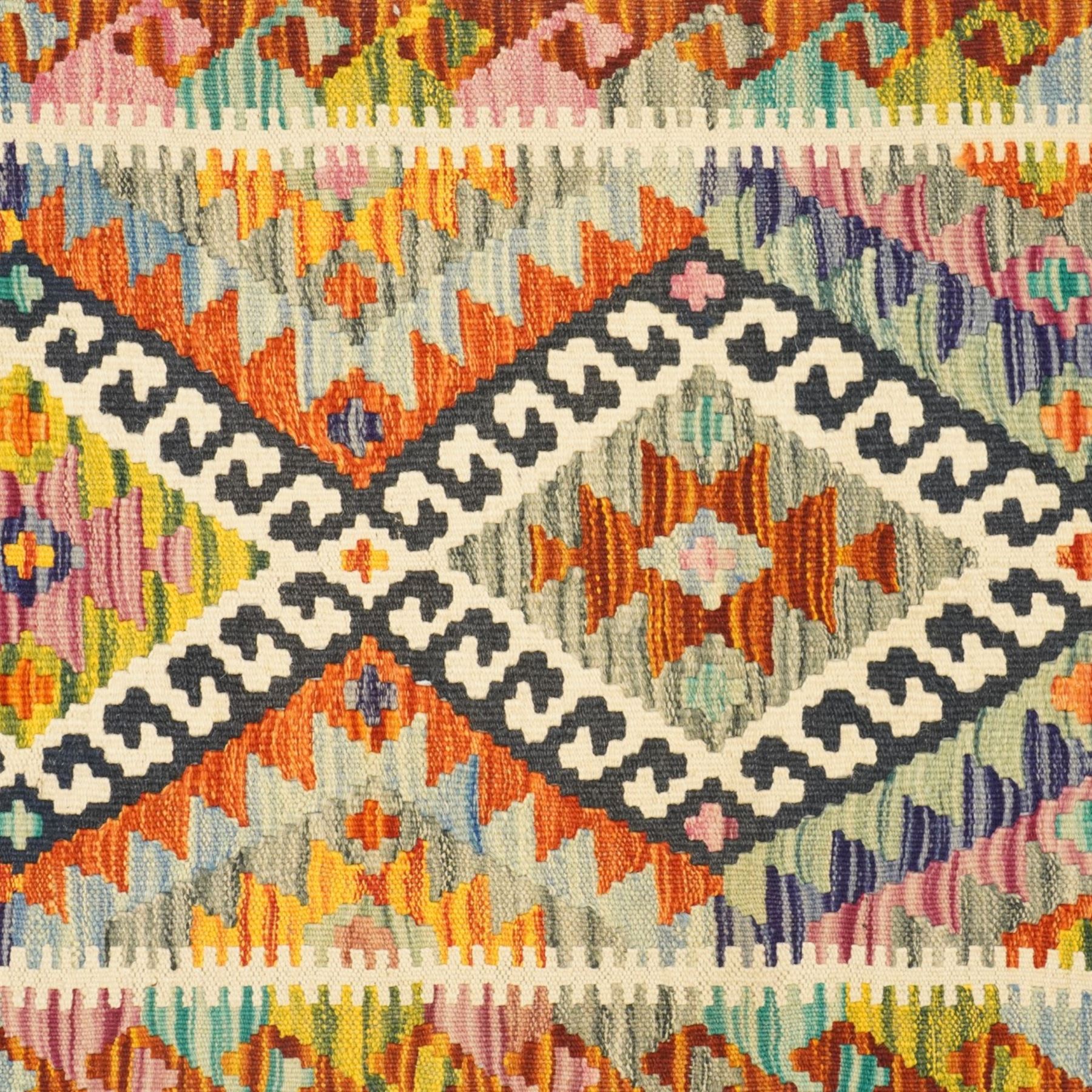 Afghan Chobi flatweave kilim runner, with a repeating stepped diamond medallion design in ivory, green, rust, teal, purple, indigo, and framed by chevron and geometric borders
