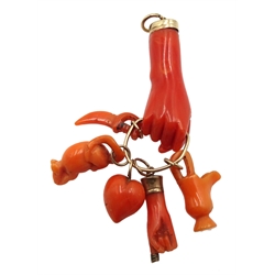 Victorian gold carved coral hand charm holding a heart, hand, jug, sword and mouse
