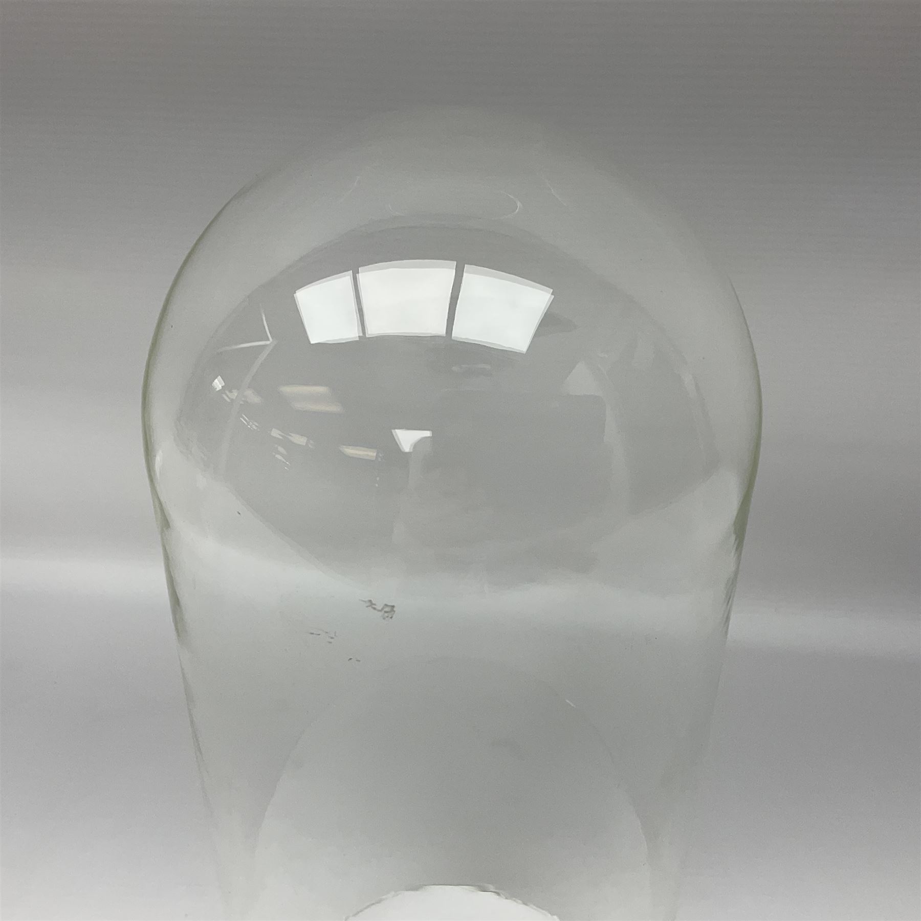 Tabletop glass display cabinet, with hinged door, together with two glass domes