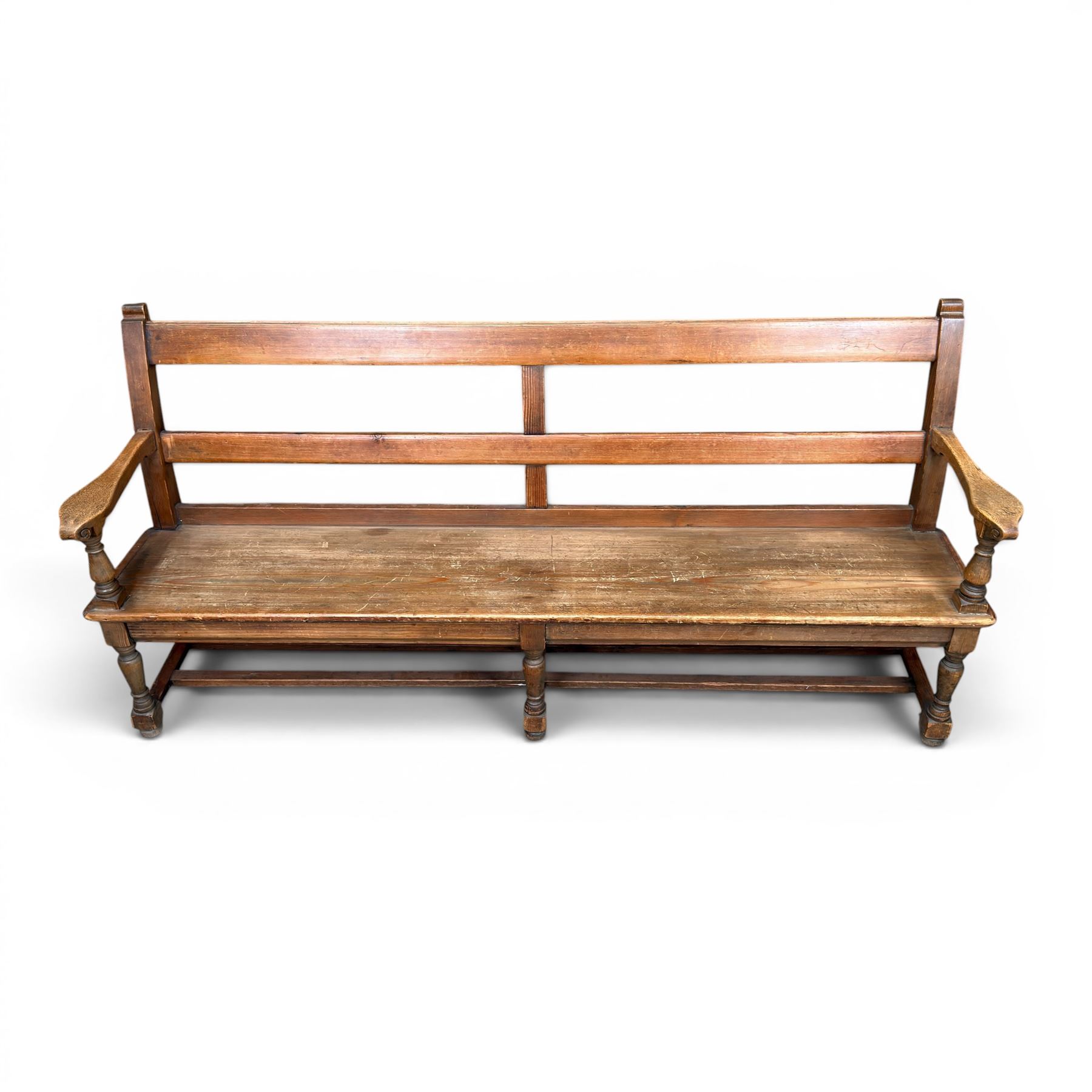 Early 20th century pine and oak bench seat, stained pine rail back frame with shaped oak arms