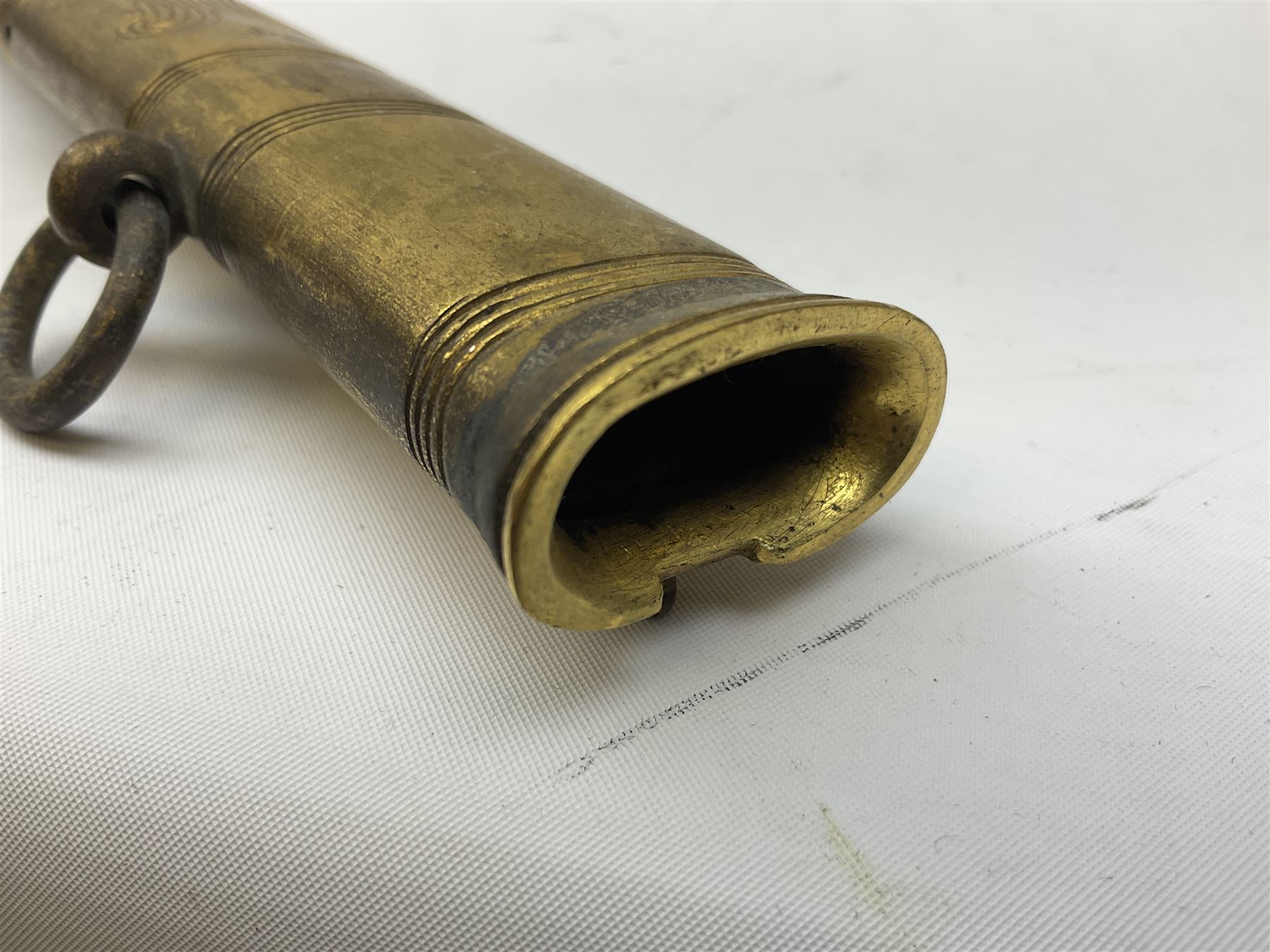 WW1 George V era 1827 Pattern Royal Naval Officer’s sword, the 80cm fullered steel blade decorated with crown, fouled anchor etc and marked Gieves Portsmouth London Edinburgh Devonport to the ricasso, gilded hilt with fouled anchor and crown, wire-bound ray skin grip, lion’s head pommel with mane backstrap, folding/locking langet and full bullion knot; in  leather scabbard having twin brass lockets with hand engraved panels and twin suspension rings L94cm overall. Provenance: By direct family descent from Brian Heathcote HMS Conqueror later Superintendant in the Liverpool Special Constabulary.