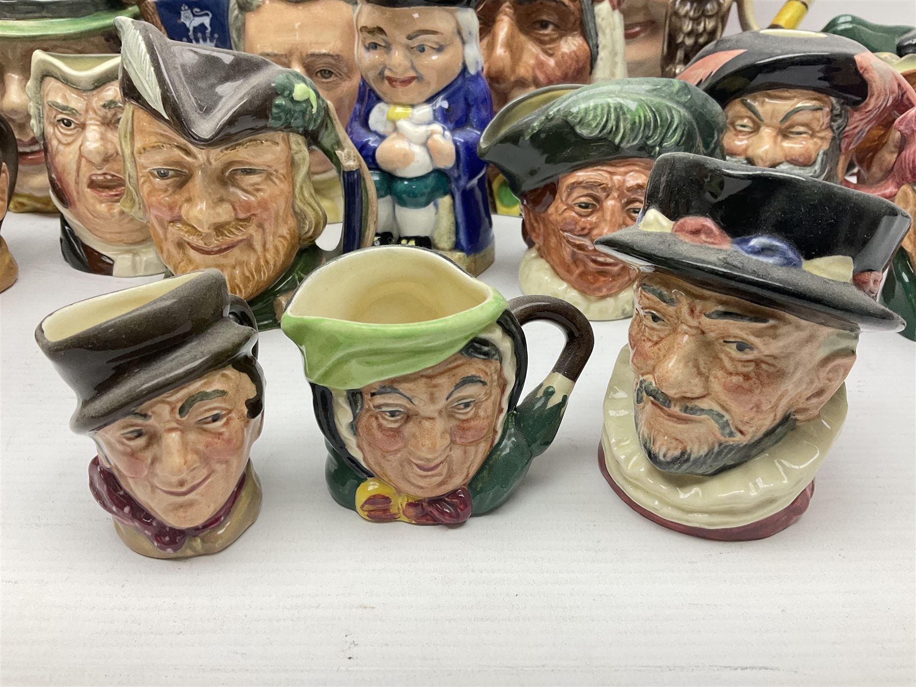 Collection of Royal Doulton and Beswick character jugs of various sizes, including North American Indian D6611, The Falconer D6533,  Tony Weller 281, Sairey Gamp 371 etc
