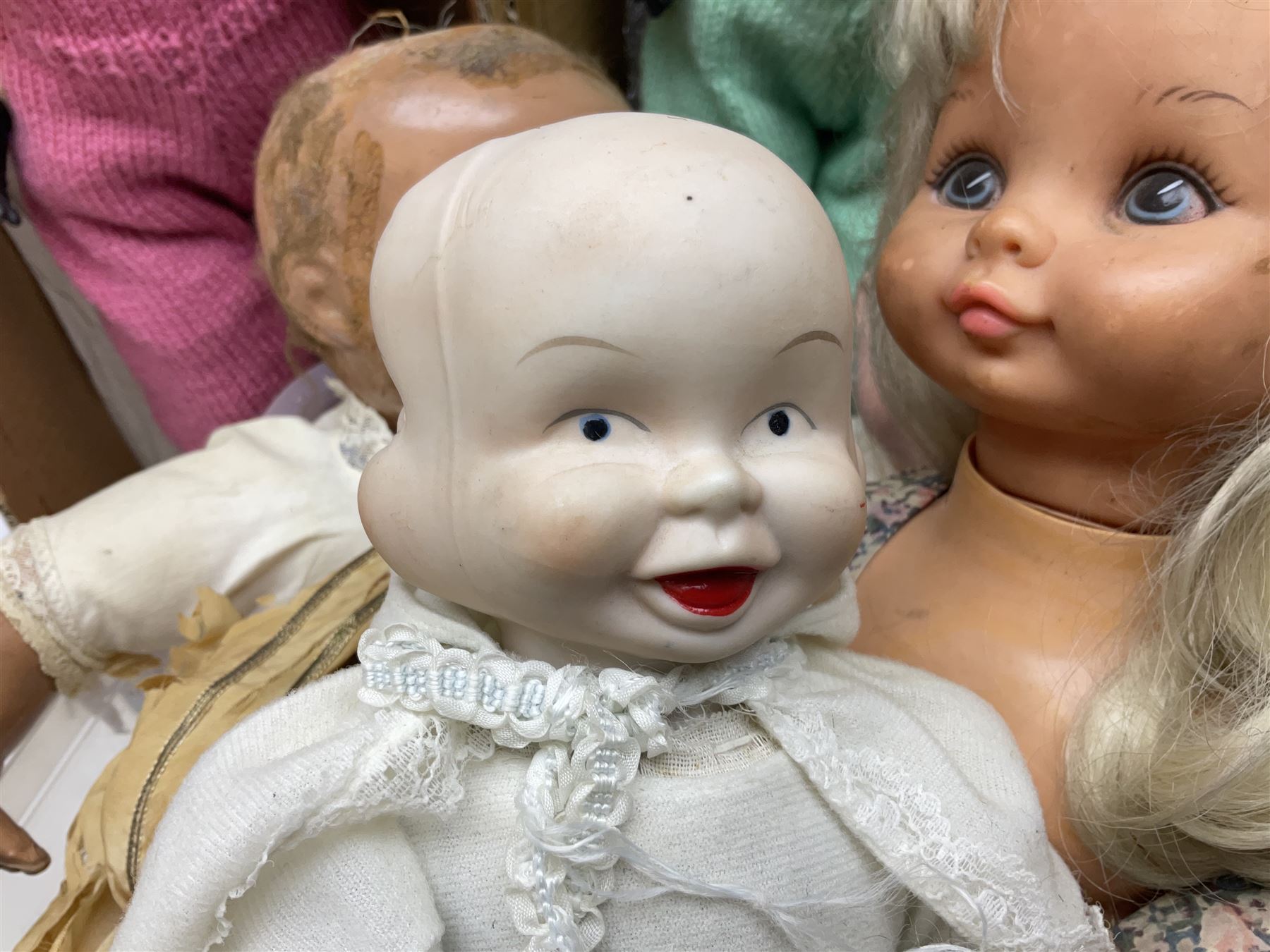 Quantity of vintage and later dolls to include unusual three faced example and further dolls marked C.J, Gloobee, Rosebud etc in three boxes