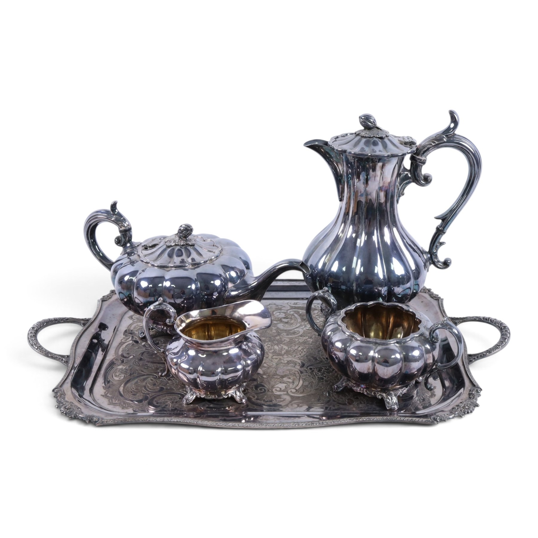 Early 20th century silver plated four piece melon-shaped tea service by James Dixon & Son Sheffield, comprising teapot, hot water jug, milk jug and open sucrier, together with a silver plated twin handled tray with engraved floral decoration