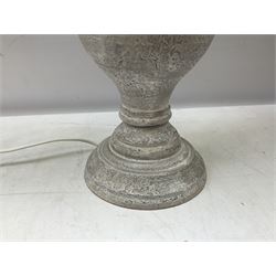 Pair of composite grey table lamps, in the form of an urn upon a circular foot, with grey linen shades
