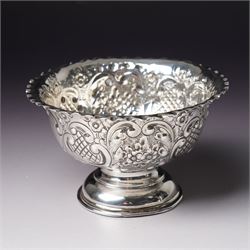 Edwardian silver bowl with embossed decoration on a short pedestal foot D11cm Birmingham 1904 Maker A & J Zimmerman Ltd and a modern silver coaster with turned wooden base D9.5cm Sheffield 2001 (2)