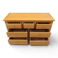 Solid oak chest of drawers, three over four drawers with metal pulls 