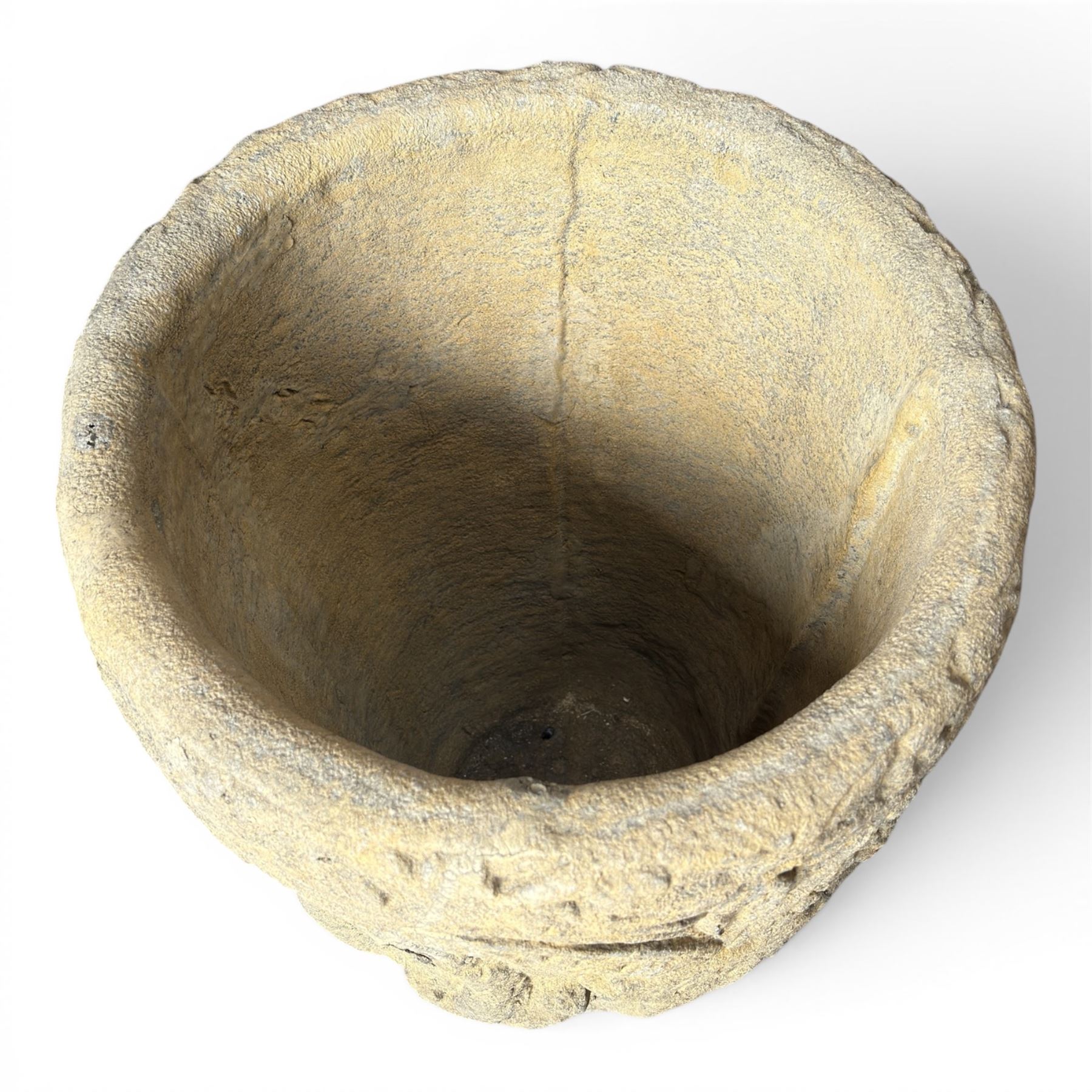 Cast stone Romanesque design urn of tapering form, decorated in relief with motifs of zoomorphic figures and swans within foliate and guilloche cast architectural arches with Neoclassical columns, in weathered finish