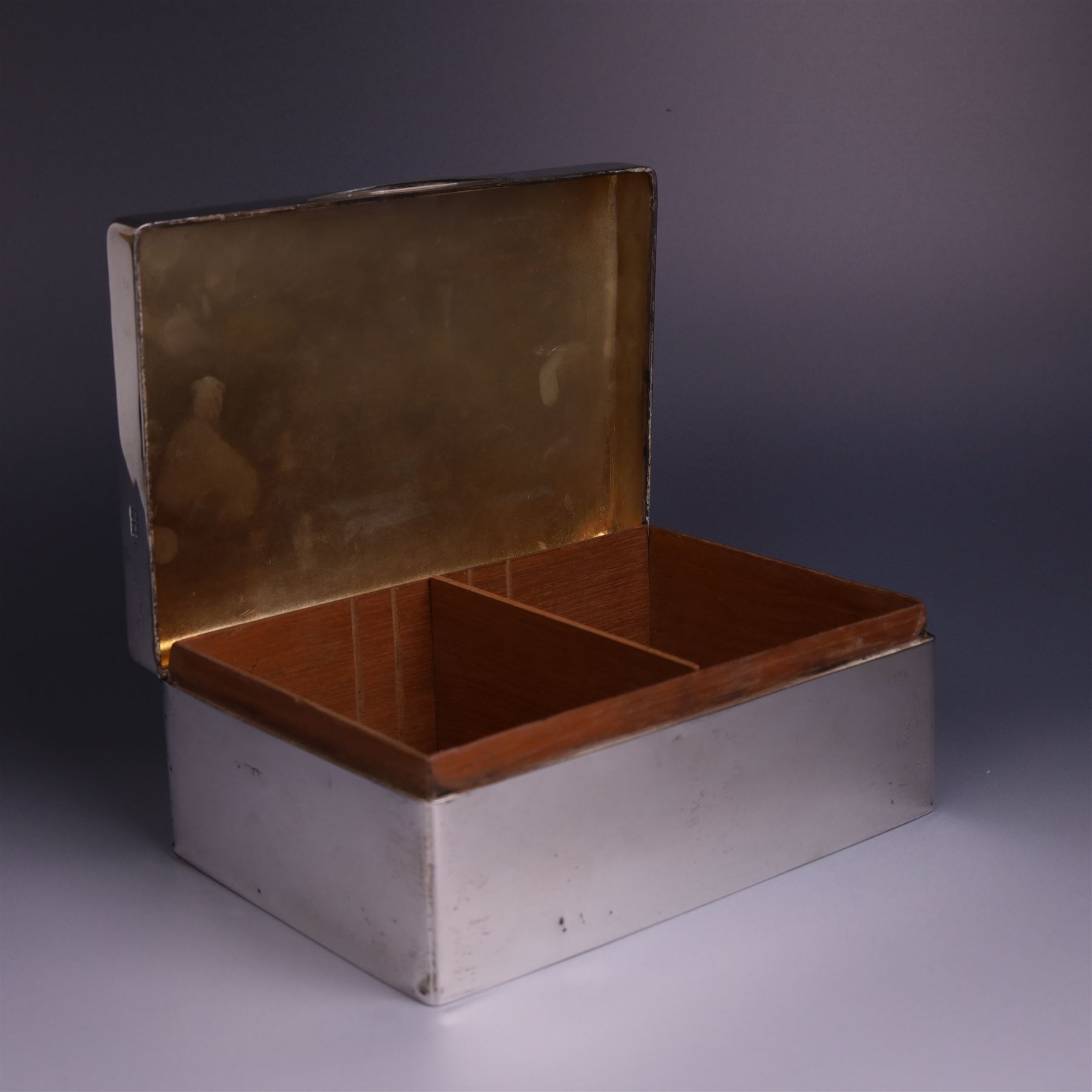 WWII silver mounted cigarette box, of rectangular form, the hinged cover inscribed 'presented to Major & Mrs James Bennett on the occasion of their marriage by the officers of the Liverpool Wardens Service October 1944' and engraved with twenty-four signatures of the officers, with softwood interior, hallmarks worn and indistinct, H7.5cm, W19cm