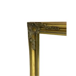 Large rectangular wall mirror, swept gilt frame decorated with floral cartouches, bevelled plate