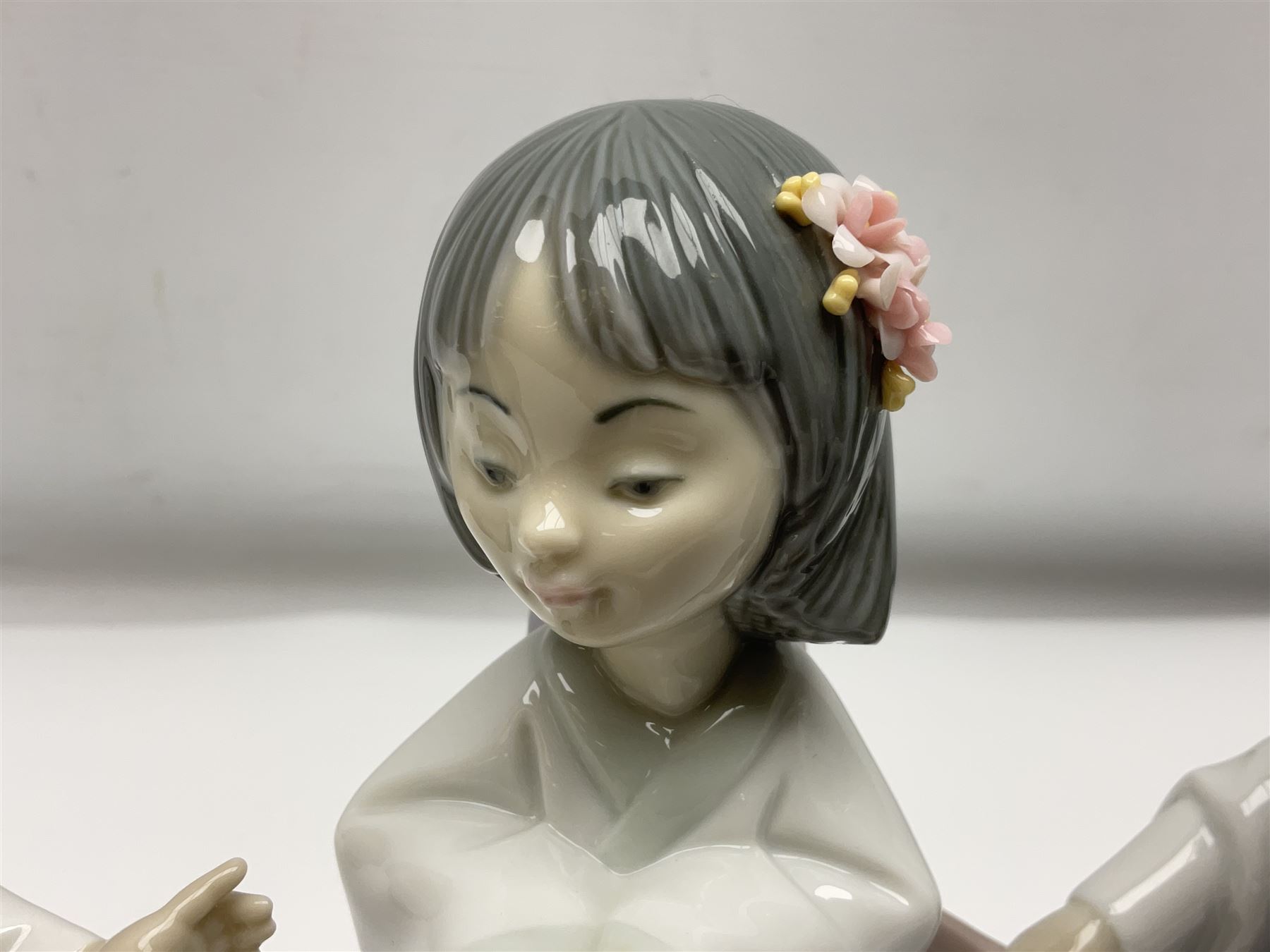 Six Lladro figures of the China doll set and Oriental doll set, comprising Playing the Flute no.6150, Bearing Flowers no.6151, Flower Gazer no. 6152, Oriental Dance no. 6230, Oriental Lantern no. 6231 and Oriental Beauty no. 6232, largest H20cm