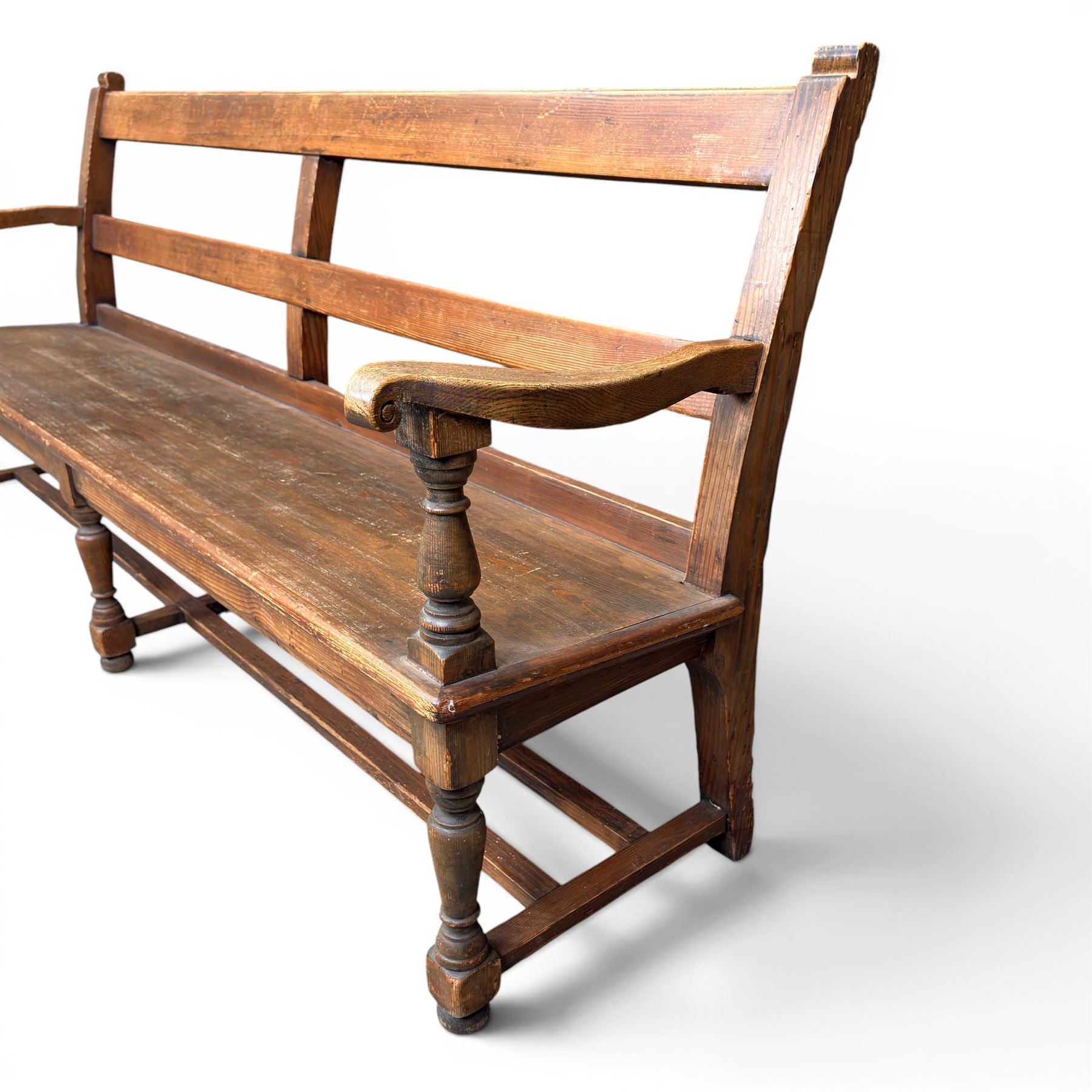 Early 20th century pine and oak bench seat, stained pine rail back frame with shaped oak arms