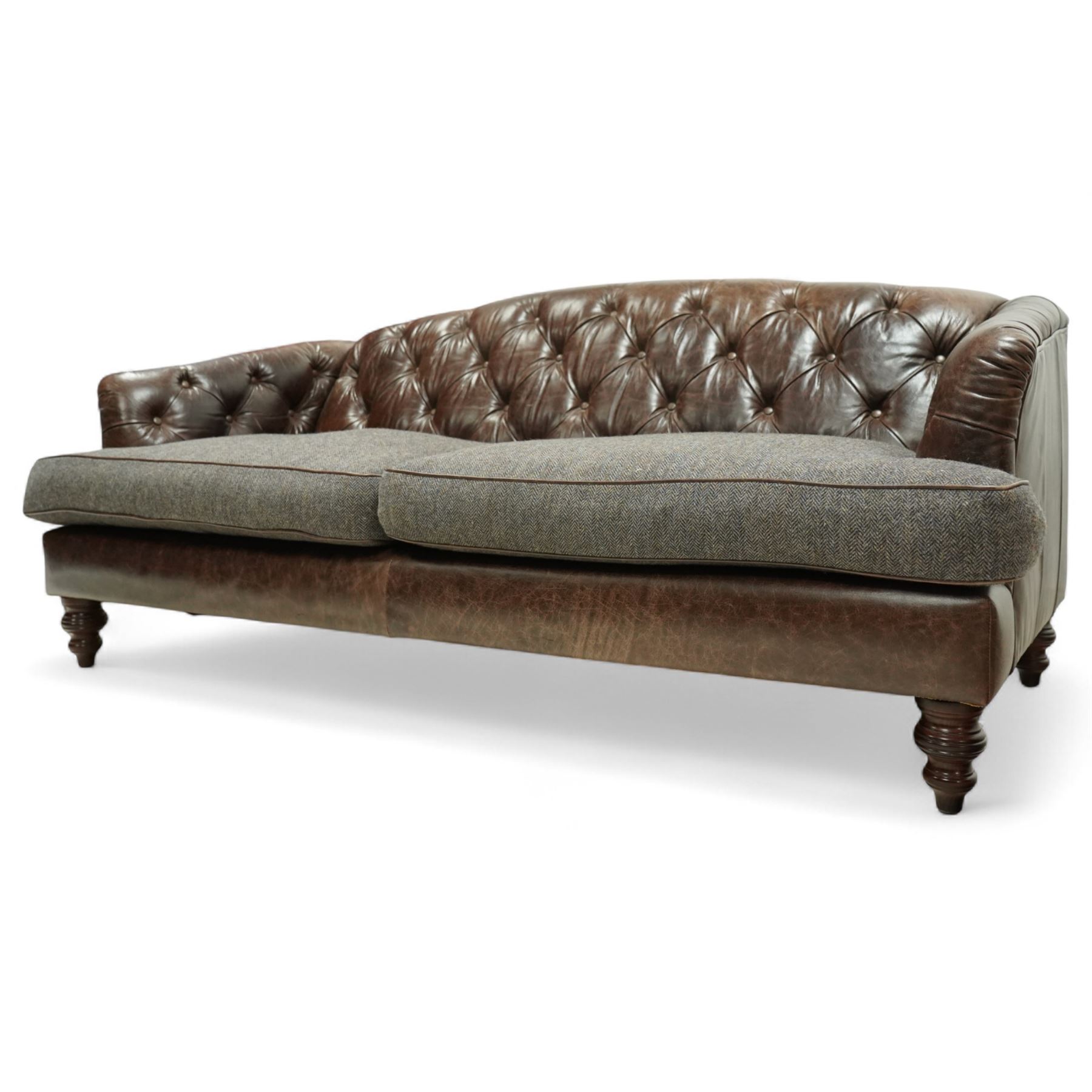 Tetrad - Harris Tweed and leather upholstered Chesterfield sofa, curved back and arms  with deep buttoned brown leather upholstery above loose herringbone tweed seat cushions with brown leather piping, raised on turned wooden feet 