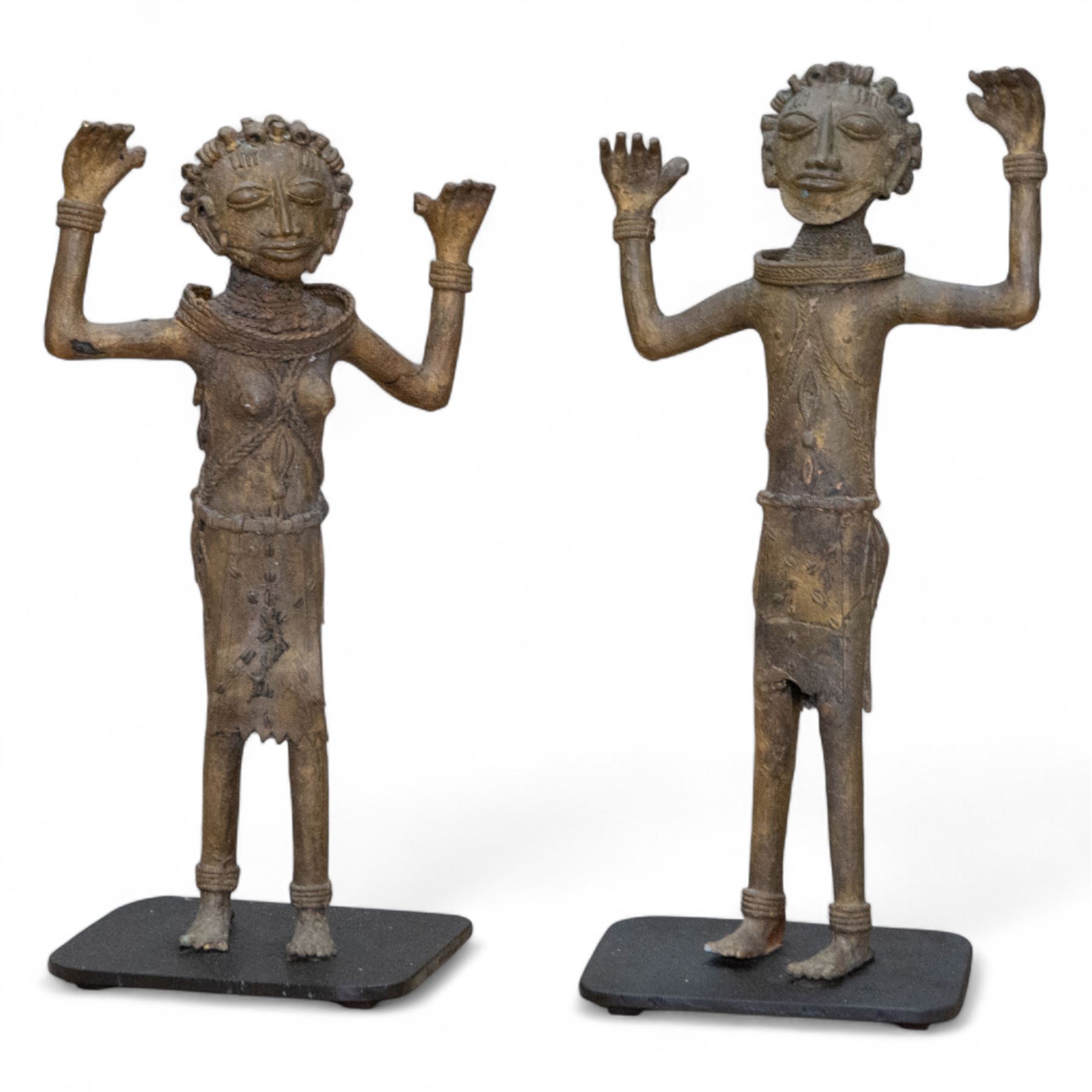 Pair of Benin bronze statures, modelled as a male and female, with armed raised, upon a square base, H76cm