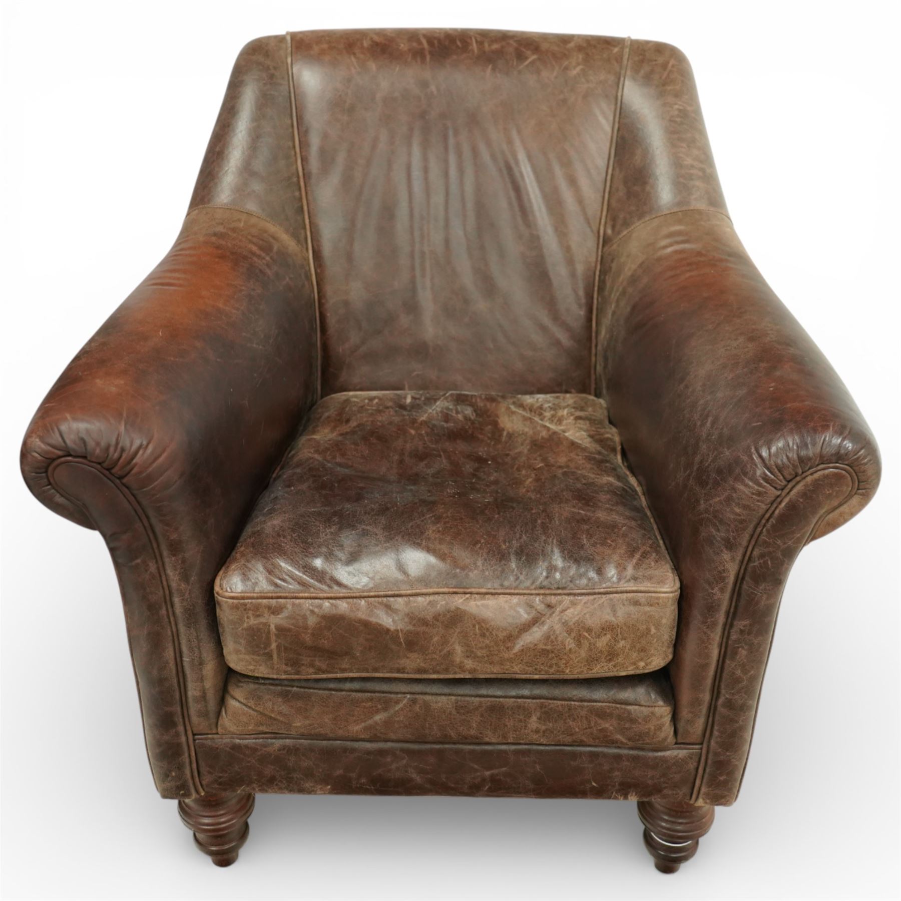 Tetrad - late 20th century leather armchair, upholstered in brown leather with a gently curved back and rolled arms, loose seat cushion over a padded base, raised on turned wooden feet