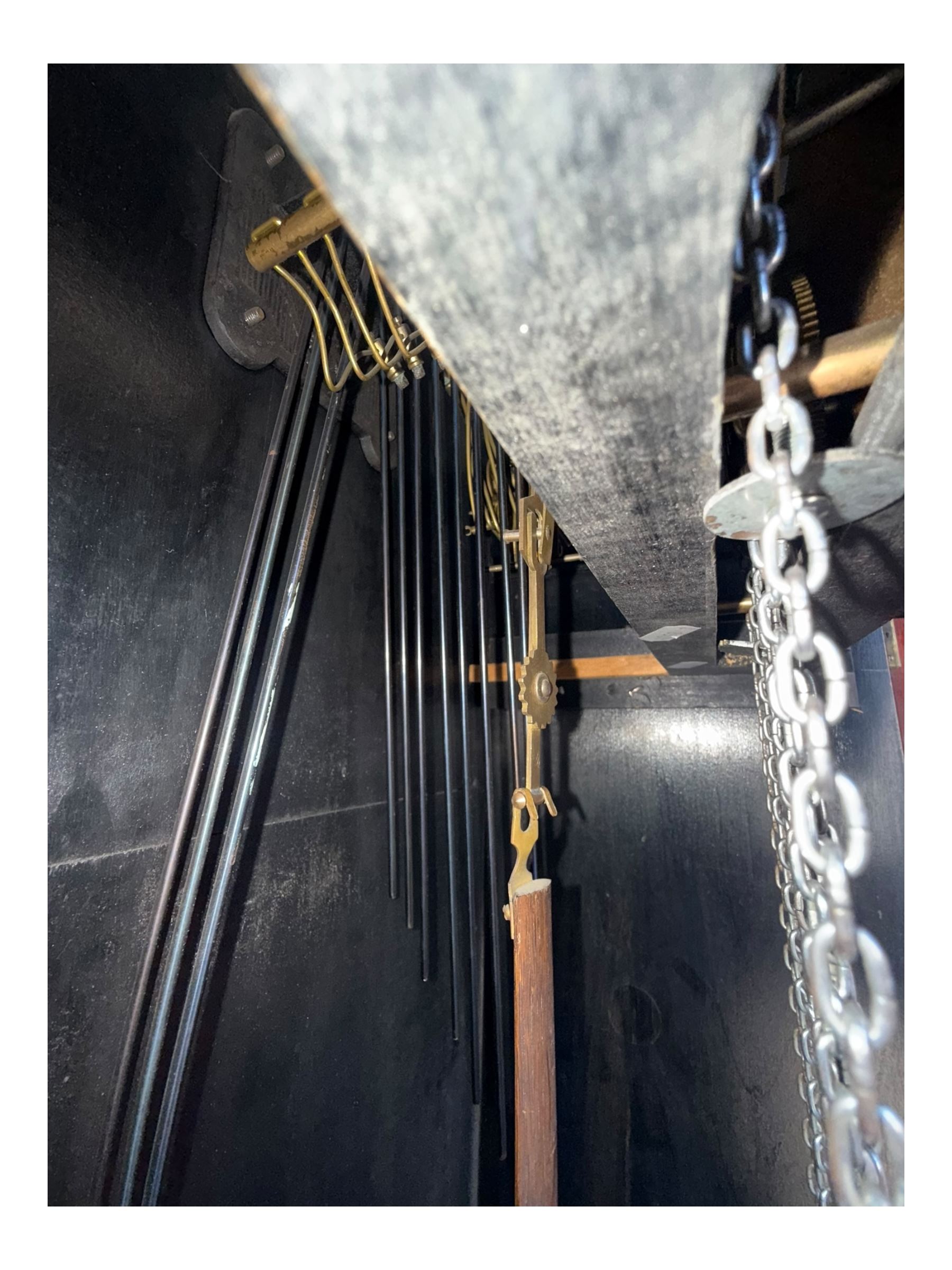 English- Art deco mahogany 8-day longcase clock, with an arched top and fill length fully glazed door beneath, on a short plinth with bracket feet, three train chain driven movement with visible stainless steel cased weights and pendulum, silvered dial with Arabic numerals, minute track and pierced steel hands, quarter chiming movement with  Westminster/ Whittington/ strike/silent selection.
