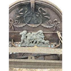 Cast iron dog grate, cast plaque and arch surround