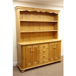  Waxed pine traditional dresser with raised two tier plate rack, projecting cornice, four drawers flanked by cupboards, bun feet, W171cm, H201cm  