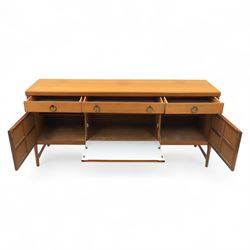 Nathan - mid 20th century teak sideboard, fitted with three drawers with brass ring handles, above a central fall front cabinet, flanked by two cupboard doors, raised on square tapering supports