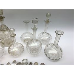 A group of Victorian and later glass decanters, to include two Newcastle examples, the other examples of bulbous form with various cut and engraved decoration, together with a quantity of various glass stoppers. 