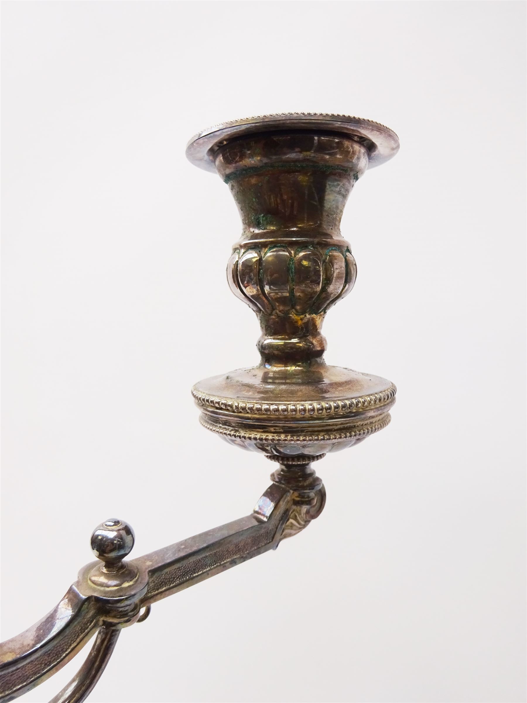 A large Victorian Thomas Bradbury & Sons silver plated candelabrum, the circular base with flower head border upon three domed feet, supporting a central knopped and fluted column flanked by three zoomorphic creatures, leading to a central socket with removable nozzle above a large palmette detailed drip pan, and three scrolling branches with conforming sockets and nozzles, with maker's silver plate mark and Victorian registration lozenge beneath, H62.5cm