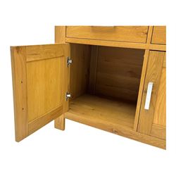 Light oak sideboard, fitted with three drawers and three cupboards, metal handles