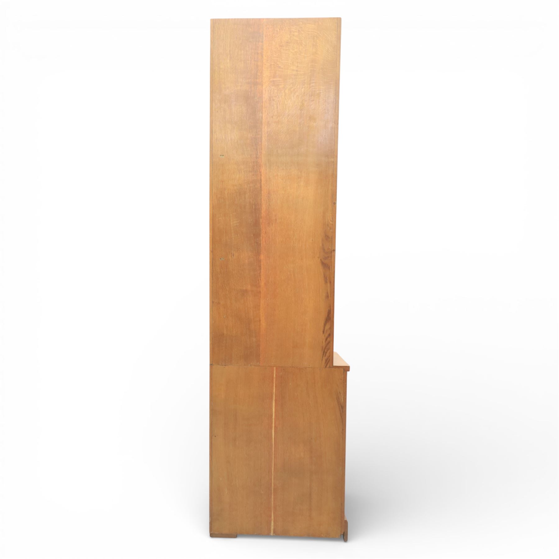 Cat & Mouseman - oak corner cabinet, glazed door with two fixed glass shelves, above a panelled door and sides raised on a plinth base, with cat and mouse carving to the lower side by Lyndon Hammell a former apprentice of Robert 'Mouseman' Thompson