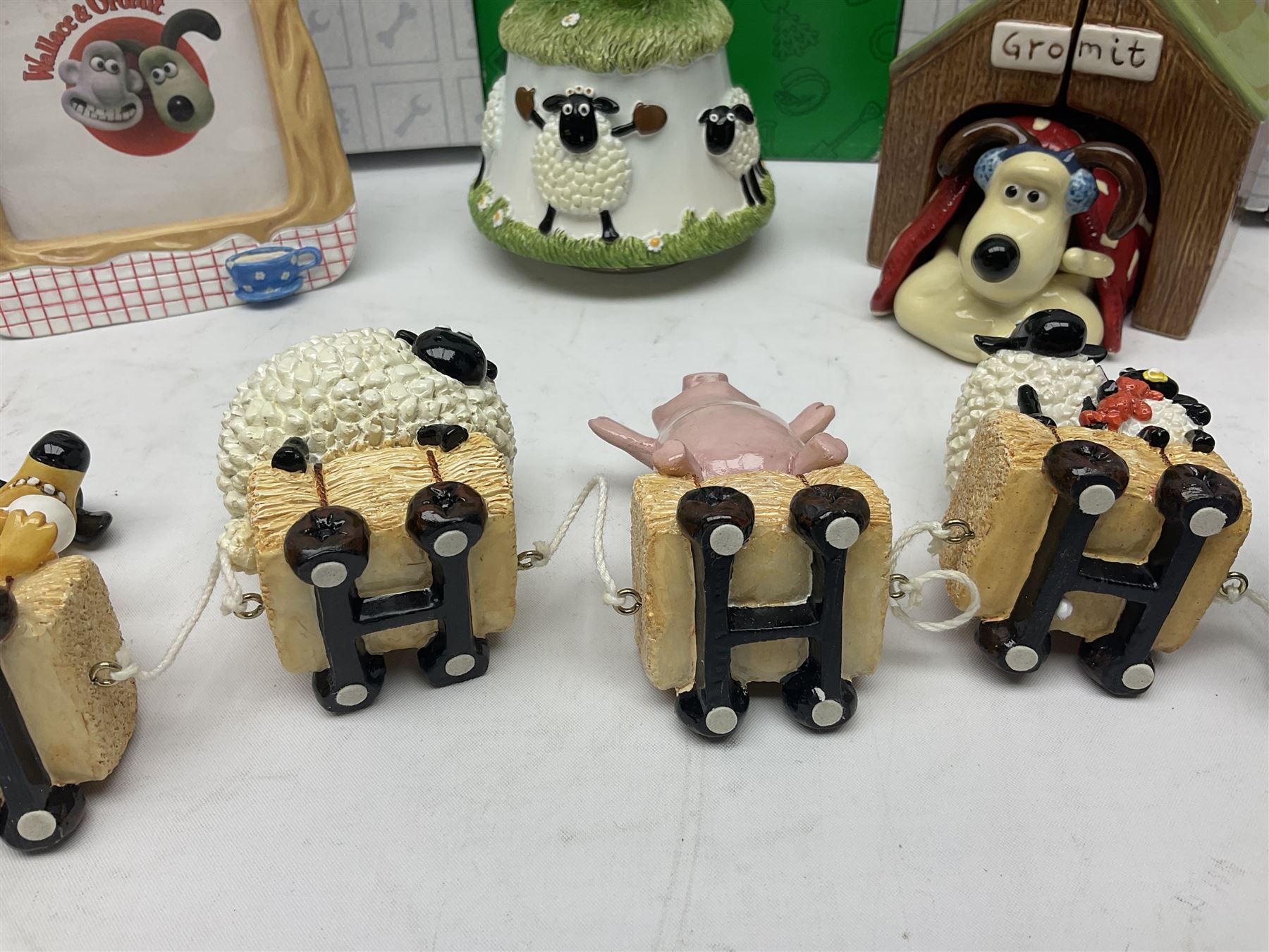 Border Fine Arts Shaun The Sheep Tractor Train and musical figure, together with a Wallace and Gromit photograph frame and a Gromit cruet sett, three in original boxes  