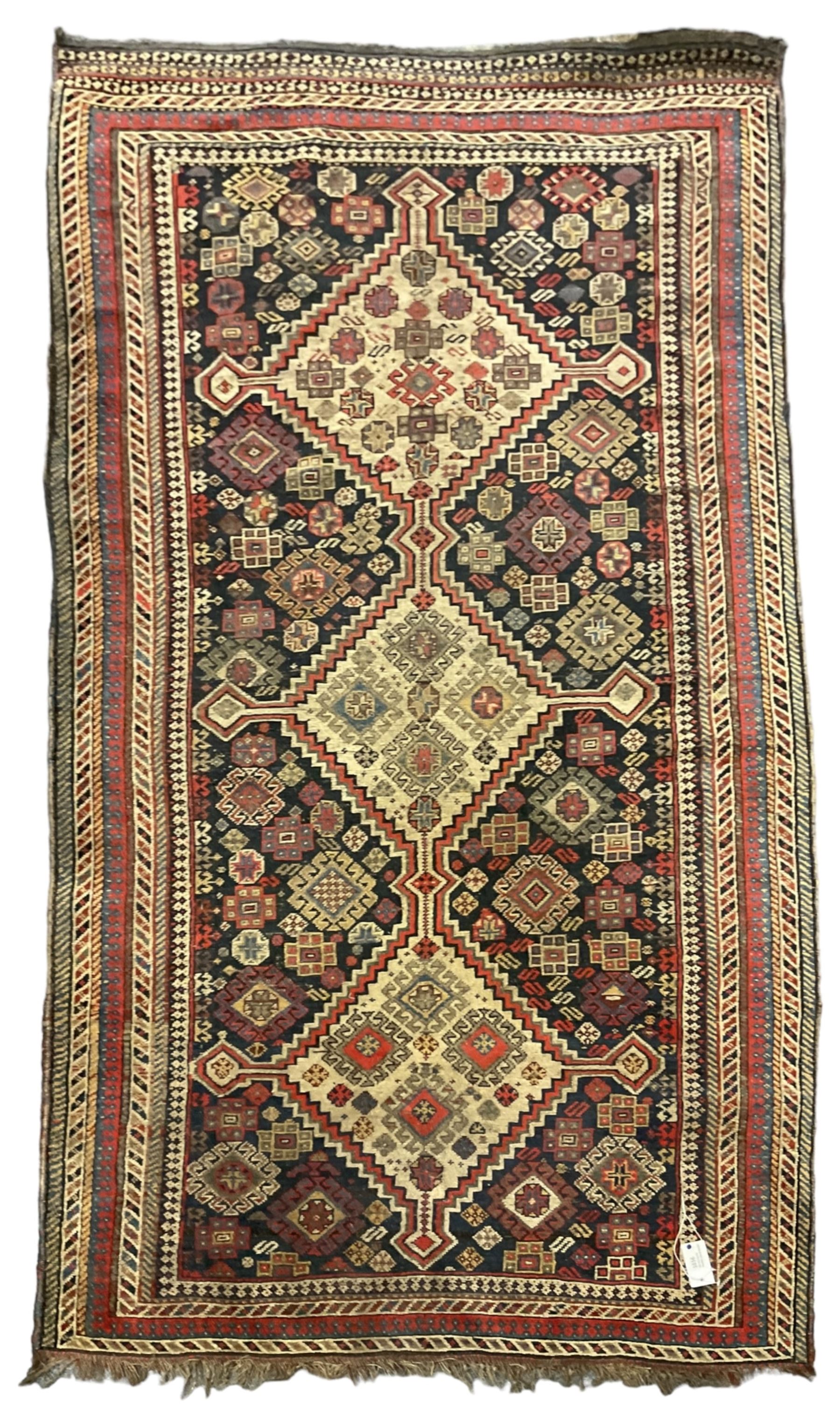Old Persian Hamadan rug, the indigo ground field with three interlinked lozenge medallions, decorated all over with geometric and stylised motifs, eight band border with repeating geometric patterns 