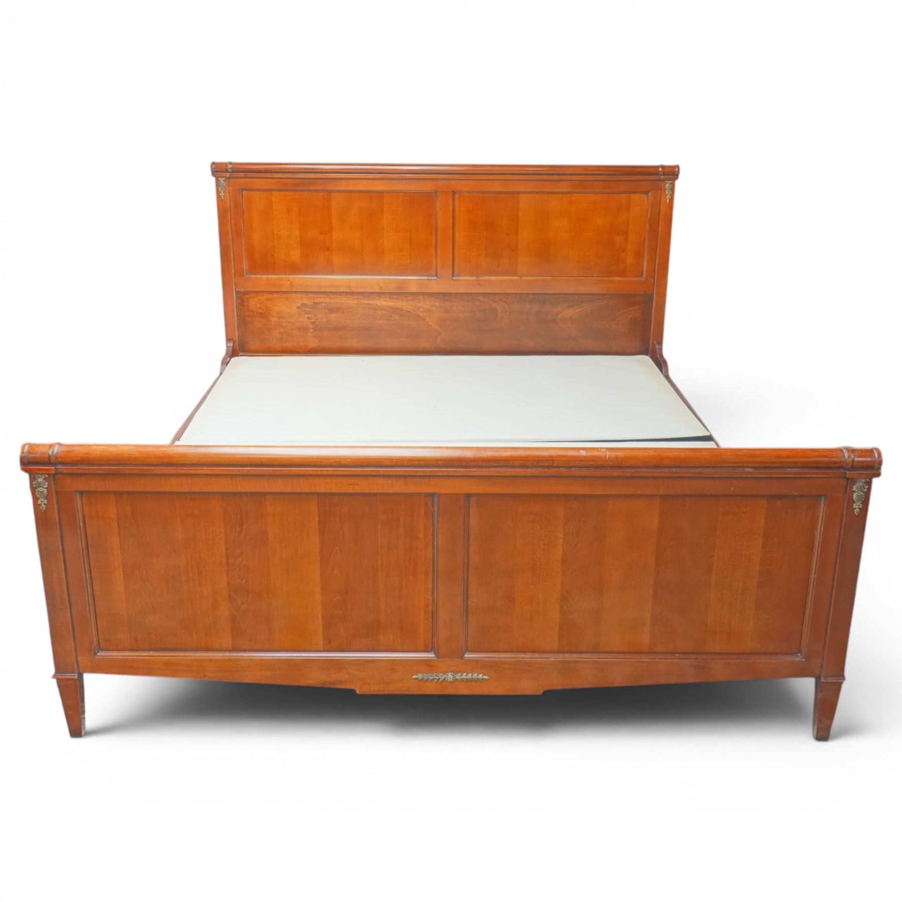 And So To Bed - cherrywood 6' super king 'Nathalie' bed, the panelled headboard and footboard with cylindrical rolled rails, decorative brass mounts to the corners, on square supports with cream and black edged fabric covered base panels 