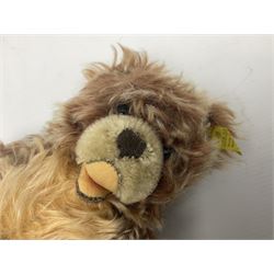 Steiff teddy bear with golden plush body, revolving head, applied eyes, vertically stitched nose and mouth and jointed limbs; button to left ear H26cm; and two other Steiff teddy bears, each with open mouth and button with tag to left ear (3)
