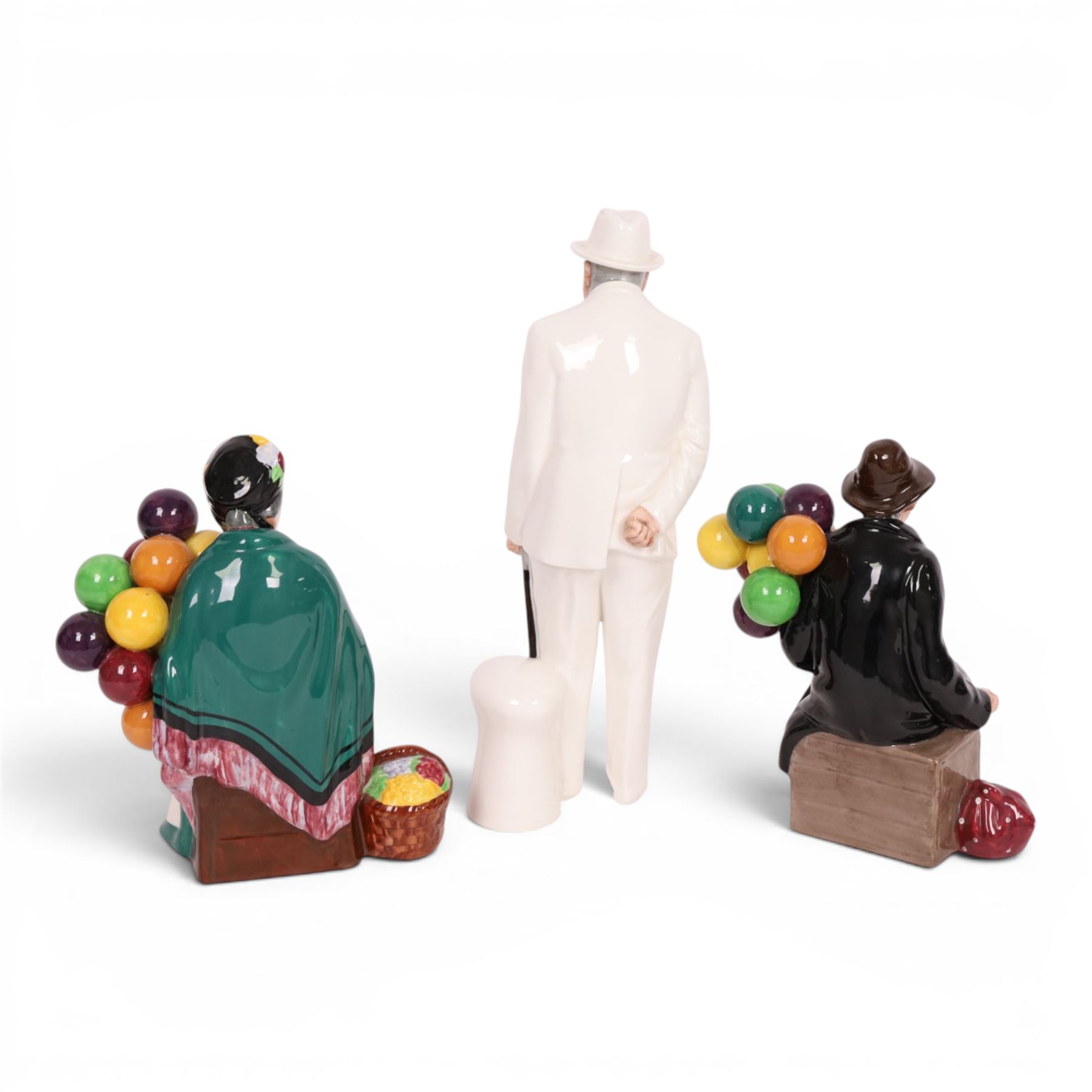 Three Royal Doulton figures, comprising  Churchill HN3057, The Old Balloon Seller HN1315 and The Balloon Man HN 1954