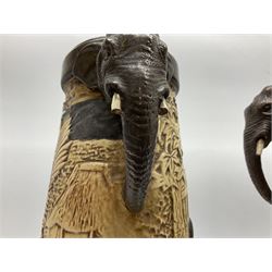 Pair of Bretby vases of tapering cylindrical form decorated with elephants, cranes and fishermen, the bodies with twin elephant mask handles, with coppered borders, raised upon three bun feet, stamped Bretby 2246 marks beneath, H32cm