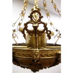  Large Regency style gilt metal electrolier, six scroll branches, foliate cast dome base, six conforming suspension chains and glass shades, H88cm   