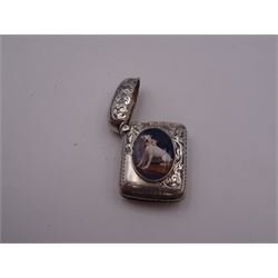 Victorian silver vesta case, of rounded rectangular form engraved with foliate scrolls, the front with applied oval enamel panel depicting a seated dog with pink bow to collar, hallmarked Minshull & Latimer, Birmingham 1895, H3.5cm, approximate gross weight 0.59 ozt (18.3 grams)
