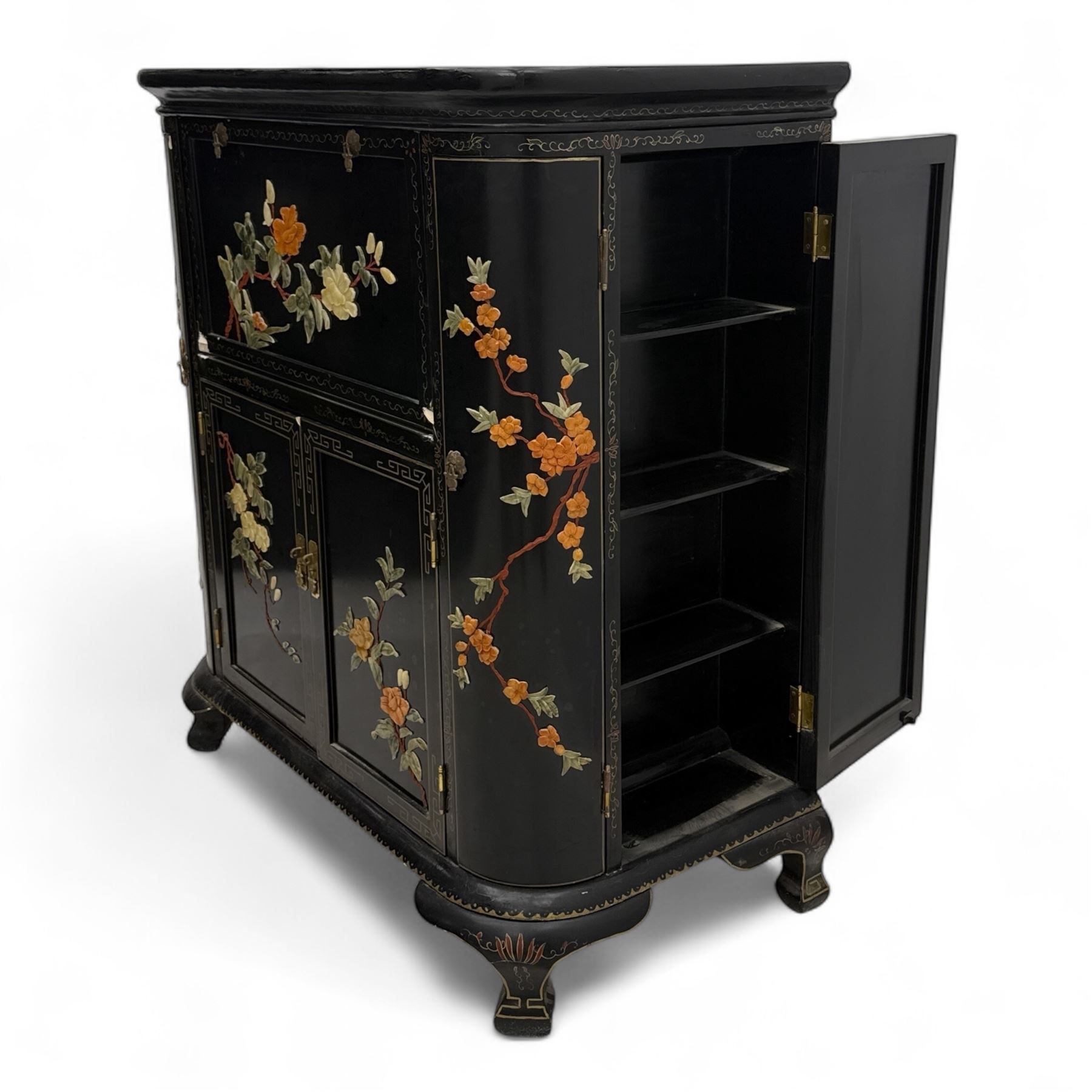 Early 20th century Chinoiserie lacquered cabinet, rounded rectangular top above a fall front enclosing fitted interior with lacquered decoration, over a pair of cupboard doors and flanked by side compartments with tiered bottle shelves, the black lacquer ground decorated throughout with raised and painted floral sprays, on shaped bracket feet