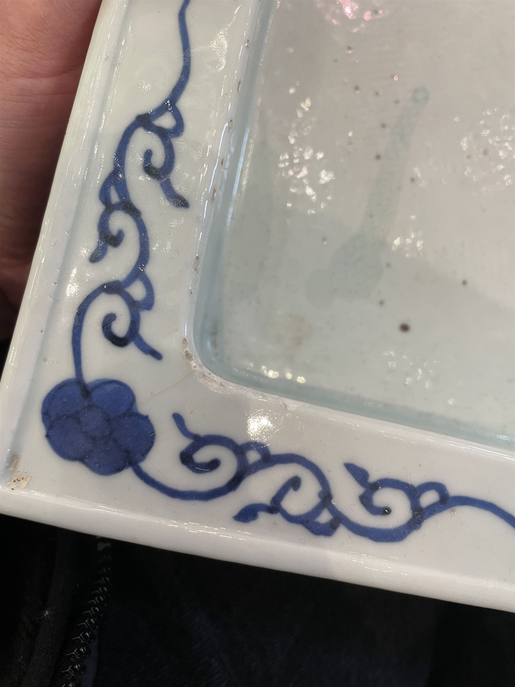 Chinese blue and white planter and stand, each of square slightly tapering and flared form, the planter decorated with two dragons and blossoming peonies, between stylised borders, the stand decorated with flower heads and vines, planter H30cm W29cm, stand H7cm D28.5cm